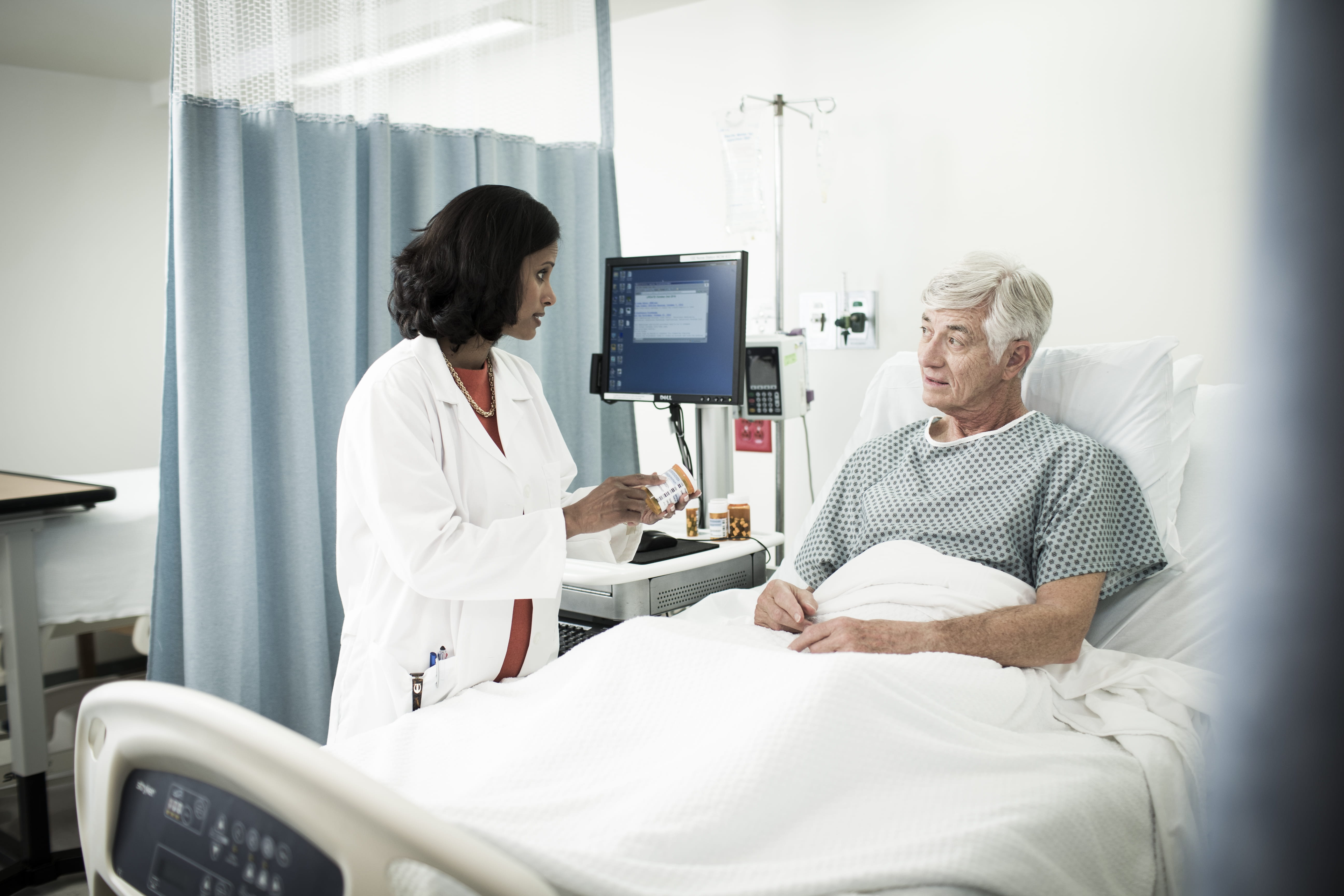 Physician discussing medication bedside